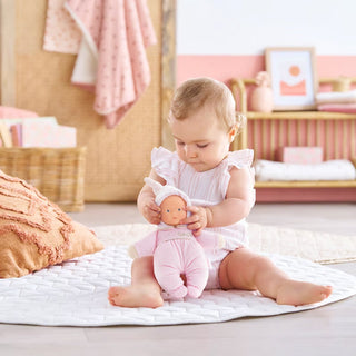 Corolle Babidoux Plush Doll -  Starry Dreams
Baby in a white dress playing with a doll on a mat in a nursery.
