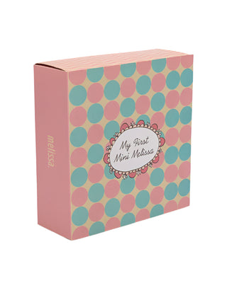 Mini Melissa My First Melissa - Pearly White Box with polka dot pattern and 'My First Mini Melissa' text on a light gray background