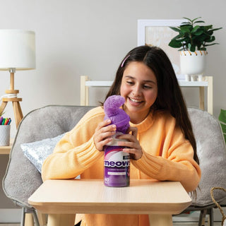 Schylling Misfittens Surprise Cat Woman holding a purple bottle labeled 'Klean Kanteen' in a home setting