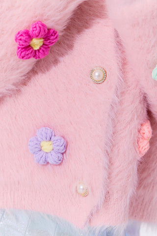 Lola and The Boys 3D Rainbow Daisy Cardigan Close-up of a pink textured fabric with decorative flowers and pearls.