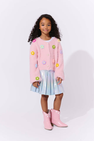 Lola and The Boys 3D Rainbow Daisy Cardigan Young girl wearing a pink sweater with colorful flowers, a light blue skirt, and pink boots on a white background