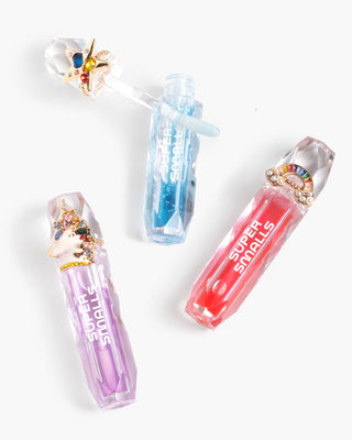 Super Smalls Gloss It Rainbow Lip Gloss Ring Set
Three colorful lip glosses with decorative caps on a white background