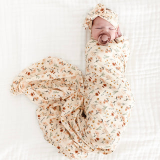 Lou Lou and Company Swaddle Blanket - Rachel
Baby swaddled in a floral blanket with a matching headband on a white background