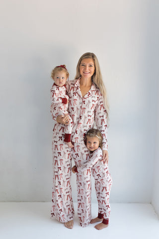 In My Jammers Merry Little Bows Women’s Set
Woman and two children wearing matching pajamas on a white background