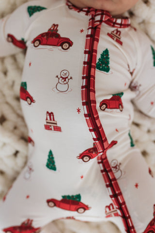 In My Jammers Red Holly Jolly Cruisers Zipper Romper
Baby outfit with Christmas-themed print and plaid trim