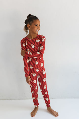 In My Jammers Santa Two Piece Set
Child wearing a red pajama set with Santa Claus pattern on a white background