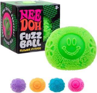 Schylling NeeDoh Flower Power Fuzz Ball Green fuzz ball with smiley face design next to its packaging on a white background