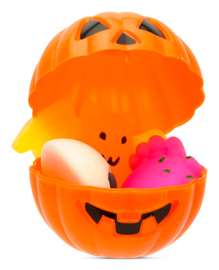 Iscream Jack-O-Lantern Surprise Toy
Orange pumpkin-shaped container with a face, holding a white egg and a pink object on a white background