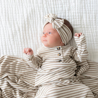 Lou Lou and Company Ribbed Headband - Indy
Newborn baby in striped outfit and headband on a textured white blanket