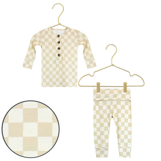 Lou Lou and Company Top and Bottoms - Austin
Checkered baby outfit with shirt and pants on hangers against a white background