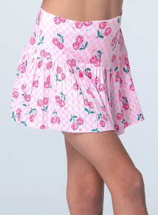 Lucky In Love Disco Cherry Pleated Skirt 
Pink floral skirt worn by a person on a light gray background