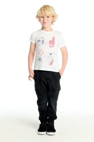 Chaser Varsity Icons Tee Child wearing a white t-shirt with colorful graphics and black pants on a white background