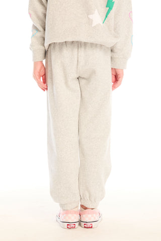 Chaser Winter Love Pants
Person wearing a beige outfit with star designs on a white background