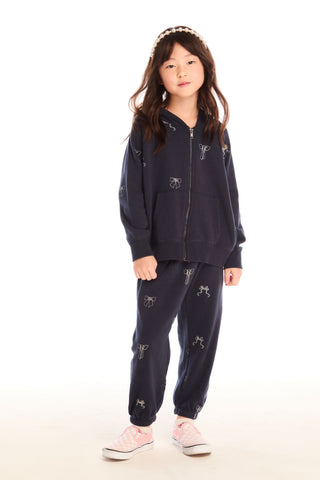 Chaser Tossed Glitter Bows Zip Up Hoodie
Child wearing a navy blue hoodie and pants with animal prints on a white background
