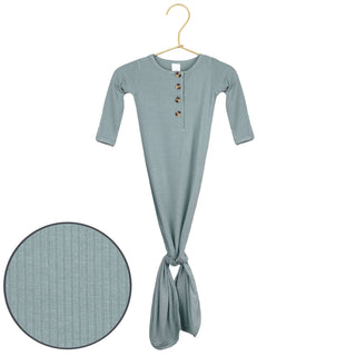 Lou Lou and Company Ribbed Knotted Gown - Ford
Light blue baby swaddle with buttons on a hanger against a white background