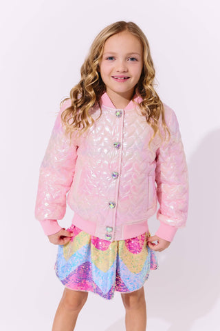 Lola and The Boys I Love You Hologram Jacket
Young girl wearing a pink sequin jacket and colorful dress on a white background