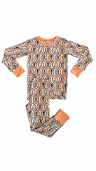 In My Jammers Orange Howl-O-Ween Pups Two Piece Set
Children's pajama set with patterned design on a white background