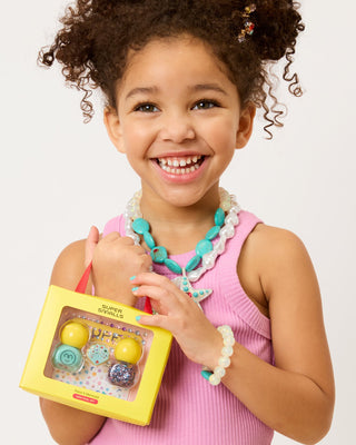 Super Smalls Paint It Mermaid Mini Nail Kit Child holding a Fisher-Price jewelry set with a white background