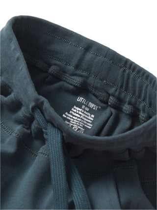 Little Bipsy Jogger - Night Fall 
Close-up of dark gray sweatshirt with 'Little Ripsy' label on a light gray background