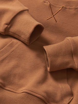 Little Bipsy Pocket Pullover - Chestnut Close-up of a brown sweatshirt with a logo on the chest.