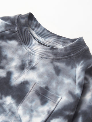 Little Bipsy Marble Pullover - Blue
Close-up of a gray tie-dye sweatshirt with a pocket on a light background