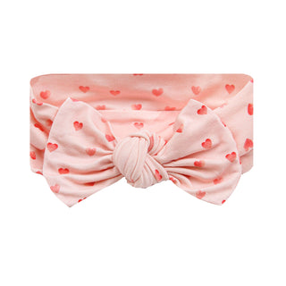 Lou Lou and Company Headband - Miley
Pink headband with a bow and heart patterns on a white background