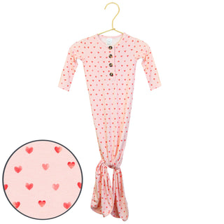 Lou Lou and Company Knotted Gown - Miley
Pink baby onesie with heart pattern on a hanger against a white background