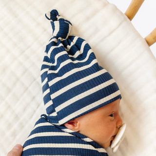 Lou Lou and Company Ribbed Top Knot Hat - Jack
Baby wearing a blue and white striped hat on a white blanket