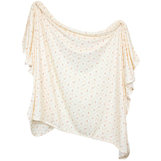 Lou Lou and Company Swaddle Blanket - Annie Light-colored scarf with subtle pattern on a white background