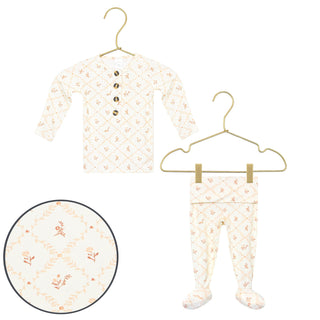 Lou Lou and Company Top and Bottoms - Annie
Baby onesie and footed pants with floral pattern on hangers against a white background