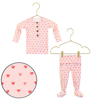 Lou Lou and Company Top and Bottoms - Miley
Pink children's outfit with red heart pattern on hangers against a white background