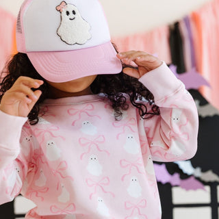 Sweet Wink Coquette Ghost Patch Halloween Trucker Hat - Pink/White 
Person wearing a pink cap with a ghost design and a matching pink sweater with ghost patterns.