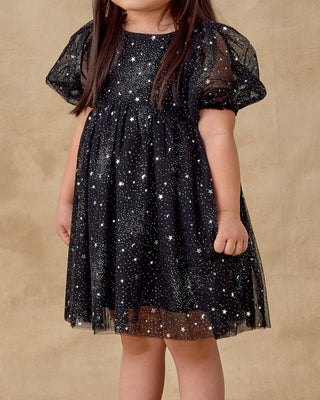 Noralee Luna Dress - Night Sky
Child wearing a black dress with star patterns on a beige background