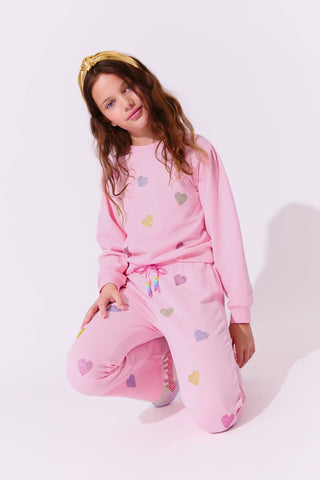 Lola and The Boys Pink Crystal Hearts Set
Young girl wearing pink pajamas with heart patterns on a white background
