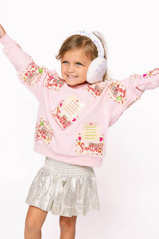 Princess of Sparkles Queen of Sparkles KIDS Letters to Santa - Pink 
Child wearing a pink sweater with colorful designs and white headphones on a white background