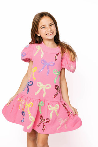 Princess of Sparkles Queen of Sparkles KIDS Sequin Multi Bow With Poof Sleeve Dress
 Young girl wearing a pink dress with colorful bow designs on a white background