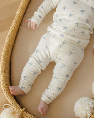 Quincy Mae Bamboo Pajama Set - Hanukkah
Baby in white outfit with floral pattern lying on a beige surface
