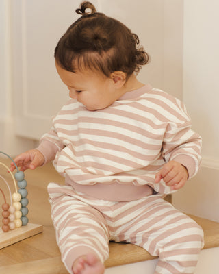 Quincy Mae Relaxed Sweatshirt & Relaxed Sweatpant Set - Pink Stripe
Child wearing a pink and white striped outfit sitting on a wooden step.