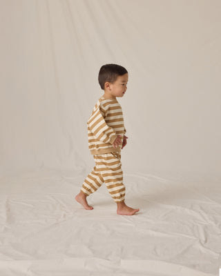 Quincy Mae Oversized Crew Sweatshirt & Oversized Sweatpant Set - Gold Stripe
Child wearing a striped outfit on a plain background