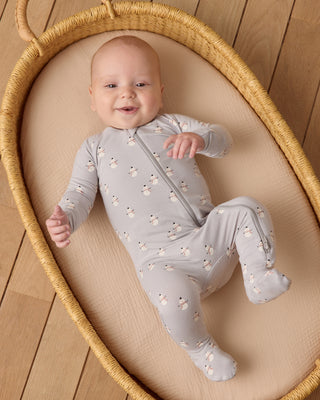 Quincy Mae Bamboo Zip Footie - Snowmen
Baby in a light gray onesie with floral patterns lying in a woven basket.