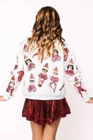 Queen of Sparkles KIDS Elf Sweatshirt - White Princess of Sparkles 
Person wearing a white sweatshirt with colorful designs and red sequin shorts on a white background