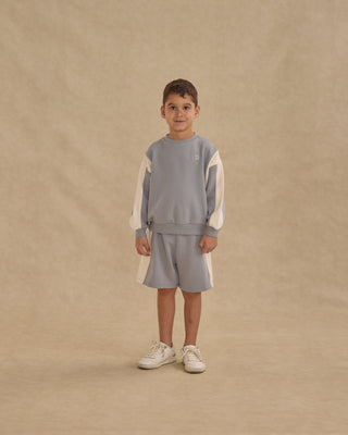 Play by Rylee & Cru Relaxed Sweatshirt - Dusty Blue
Child wearing a gray and white outfit on a beige background