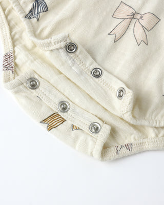 Rylee & Cru Bubble Onesie - Bows Close-up of a baby outfit with buttons and bow designs on a white background