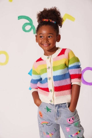 Child wearing a colorful striped sweater with a plain background