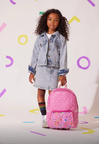 Lola and The Boys Rainbow Sparkle Denim Jacket
Young girl in denim jacket and skirt holding a pink backpack against a colorful background