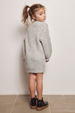 Saltwater Blossom Mini Girl Bow Dress in Heather Grey
Child wearing a gray knit dress standing against a plain wall.