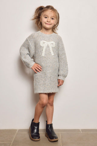 Saltwater Blossom Mini Girl Bow Dress in Heather Grey
Child wearing a gray sweater dress with a bow design on a plain background