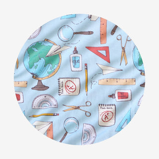 Posh Peanut Steve Ruffled Twirl Dress Fabric with educational items pattern on a light blue background