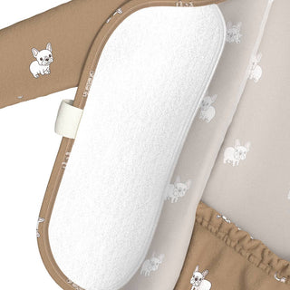 Baby bouncer with white cushion and brown sides featuring small dog illustrations on a beige background.