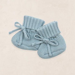 Lou Lou and Company Knit Booties - Steele
Pair of light blue knitted baby booties on a beige background